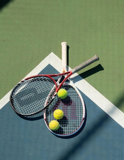 Tennis racquets and balls on a court